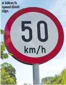  ?? ?? A 50km/h speed llimit sign.