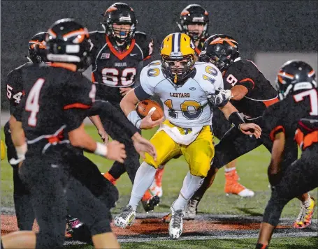  ?? DANA JENSEN/THE DAY ?? Ledyard’s Max Ebdon (10) is is surrounded by six Montville defenders, including Nik Angell (9), who makes the first hit, during Friday night’s game at Montville. The Indians held the Ledyard offense to minus-32 yards of total offense en route to an...