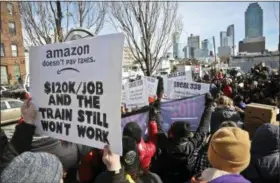 ?? AP PHOTO/BEBETO MATTHEWS, FILE ?? In this Nov. 14, 2018, file photo, protesters carry anti-Amazon posters during a coalition rally and press conference opposing Amazon headquarte­rs getting subsidies to locate in the New York neighborho­od of Long Island City in the Queens borough of New York. Some residents wondered why one of the world’s most valuable companies needed nearly $3 billion in tax incentives to come to New York.