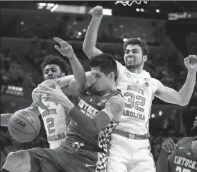  ?? ROBERT WILLETT/TRIBUNE NEWS SERVICE ?? North Carolina's Joel Berry II (2) and Luke Maye (32) battles for a rebound with Kentucky's Derek Willis (35) during the first half of the NCAA Tournament South Regional final on March 26 in Memphis, Tenn.