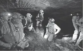  ?? TIMOTHY D. EASLEY/AP ?? Federal authoritie­s speak with workers at the Gibson North mine in Princeton, Ind., in 2015.