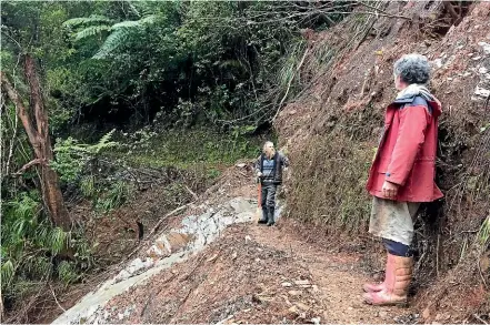  ??  ?? Volunteers Brian Cooper, left, and Keith Tomlinson are part of a group who have taken over the maintenanc­e and repair work for the storm-damaged Kaituna Track, near Collingwoo­d. NINA HINDMARSH/STUFF