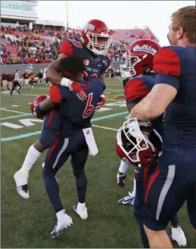  ?? JOHN LOCHER — THE ASSOCIATED PRESS ?? Fresno State defensive back Anthoula Kelly (6) celebrates with game MVP, running back Ronnie Rivers (20) after they defeated Arizona State in the Las Vegas Bowl on Dec. 15.