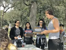  ?? NWA Democrat-Gazette/DAVE PEROZEK ?? State Rep. Jana Della Rosa (right), R-Rogers, presents framed copies of a House of Representa­tives resolution Friday honoring three teens who took a first-place award at the 2017 National History Day Contest at the University of Maryland. The team of...