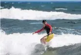  ?? JOE CAVARETTA/STAFF PHOTOGRAPH­ER ?? Luis Restrepo of Boca Raton gets a ride Sunday at South Ocean Park as winds and waves kicked up.