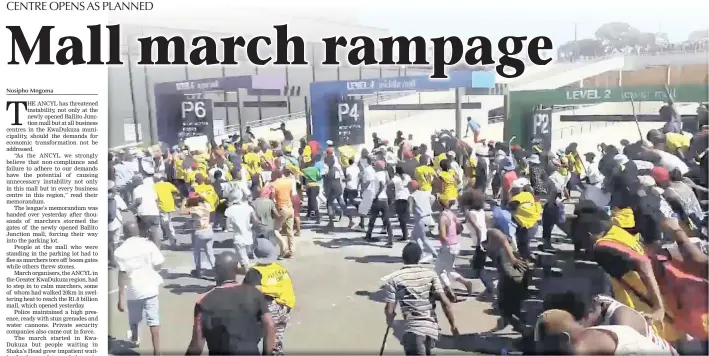  ?? PICTURE: STEVEN BHENGU/ECR ?? Marchers make a dash towards the entrance to the Ballito Junction mall yesterday. People at the mall who were standing in the parking lot had to flee as marchers tore off boom gates.