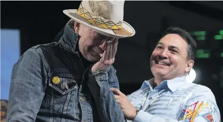  ?? — CP FILES ?? Assembly of First Nations Chief Perry Bellegarde holds an emotional Gord Downie as he is given an Aboriginal name during a ceremony honouring Downie at the AFN Special Chiefs assembly in Gatineau, Que., last December.