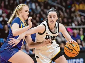  ?? Hans Pennink/associated Press ?? Iowa guard Caitlin Clark, right, was the main attraction in Monday night’s Elite Eight doublehead­er, and she delivered with 41 points and 12 assists in a victory over LSU.