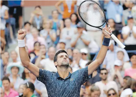  ??  ?? Serbia’s Novak Djokovic celebrates after defeating Joao Sousa of Portugal on Monday in New York.