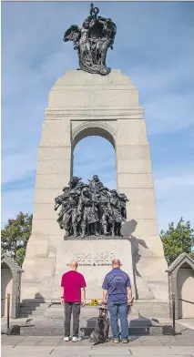  ?? ASHLEY FRASER ?? People pay respects at the cenotaph on the third anniversar­y of the fatal shooting of Cpl. Nathan Cirillo.