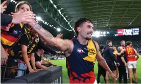  ?? Photograph: Quinn Rooney/Getty Images ?? Adelaide star Izak Rankine high fives Crows fans after the Rd 5 victory over Carlton at Marvel Stadium.