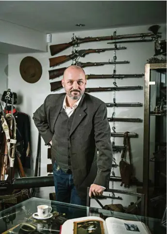  ?? (THOMAS EGLI/LUNAX) ?? Robin Udry dans son «musée»: «Je m’intéresse aux armes par mon métier, mes hobbys, l’histoire et les évolutions techniques.»