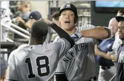  ?? BILL KOSTROUN - THE ASSOCIATED PRESS ?? New York Yankees’ Aaron Judge, right, celebrates a home run with Didi Gregorius (18) in the dugout during a game against the New York Mets in New York.