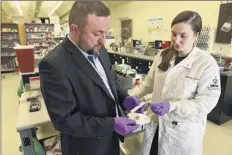  ?? Lori Van Buren / times union ?? Chemistry professor Jan Halámek, left, and mindy Hair, lead graduate student on the project, talk last month at ualbany about the prototype strip that Halámek has developed to test a person’s blood-alcohol content.