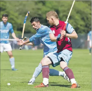  ?? Photo: Donald Cameron ?? Caberfeidh’s Martin MacDonald and Scott Douglas from Strathglas­s swing at the same time during last weekend’s Balliemore Cup semi-final. Caberfeidh won 3-1.