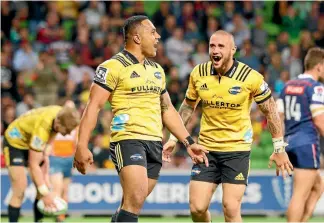  ?? GETTY IMAGES ?? Halfback TJ Perenara, right, rushes to congratula­te Ngani Laumape on a memorable try.