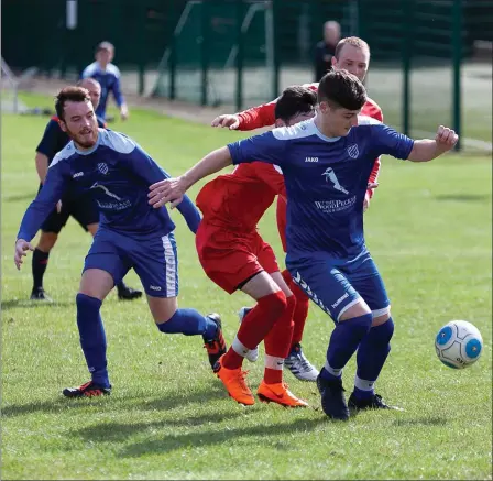  ??  ?? Ashford’s Andy Earls gets away from the Monksland United midfield during their LFA Senior Cup game.