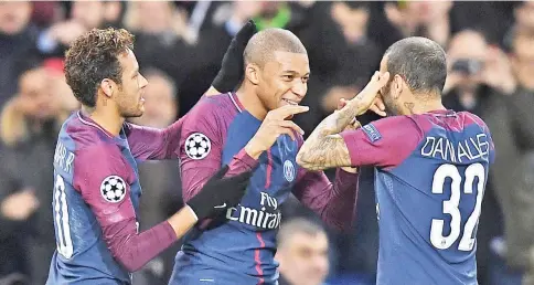  ?? — AFP photo ?? Paris Saint-Germain's French striker Kylian Mbappe (C) celebrates with teammates Brazilian striker Neymar (L) and Brazilian defender Dani Alves (R) after scoring during the UEFA Champions League Group B football match between Paris Saint-Germain (PSG)...