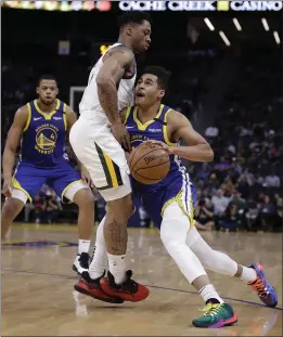  ?? BEN MARGOT — THE ASSOCIATED PRESS ?? Golden State Warriors’ Jordan Poole, right, drives the ball against Utah Jazz guard Rayjon Tucker in the second half Wednesday.