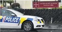  ?? PHOTO: GREGOR RICHARDSON ?? A police car sits outside Sacred Heart School in Dunedin after a pupil was grabbed by a man on a walkway yesterday afternoon, before pushing the man away and rushing back to the school.