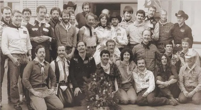  ?? STEVE BROWNING ?? Bill Klein ( front row, second from left, kneeling, in white shirt and dark vest) at a 1982 graduation of the Western Star Dancers. Mr. Klein taught square dancing to the group. Also among those pictured are Russ King ( front row, third from right), Larry Brown ( behind King in checked shirt) and Scott Carey ( center, in black cowboy hat and white shirt).