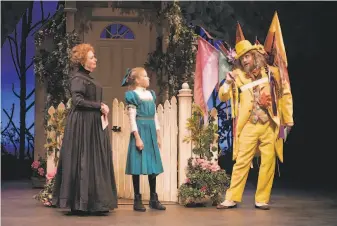  ?? Kevin Berne / TheatreWor­ks ?? Nana (Lucinda Hitchcock Cone, left) and Winnie (Natalie Schroeder) are invited to the fair by the Man in the Yellow Suit (Michael Gene Sullivan) in TheatreWor­ks’ “Tuck Everlastin­g.”