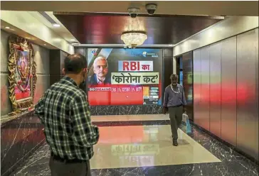  ?? — Bloomberg ?? Boosting liquidity: A screen displays an image of the Reserve Bank of India (RBI) governor Shakitanka Das inside the Bombay Stock Exchange in Mumbai recently. The RBI cut interest rates and announced steps to boost liquidity in a stimulus worth 3.2% of gross domestic product to counter the economic impact of the coronaviru­s outbreak.