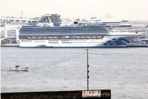  ?? Kyodo News via AP ?? ■ The Diamond Princess cruise ship is anchored Tuesday at a port in Yokohama. Japanese health officials and experts on a government panel have acknowledg­ed that the quarantine of the virushit cruise ship was not perfect but defended Japan’s decision to release about 1,000 passengers after 14 days.