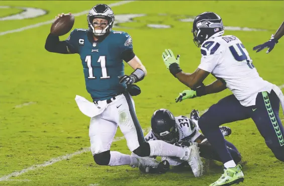  ?? MITCHELL LEFF/ GETTY IMAGES ?? Eagles QB Carson Wentz is sacked by Seahawks safety Jamal Adams during the third quarter on Monday night at Lincoln Financial Field in Philadelph­ia, Pa.