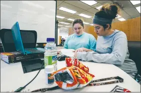  ?? Arkansas Democrat-Gazette/MITCHELL PE MASILUN ?? University of Arkansas at Little Rock nursing students Kimberly Hill and Paoloa Moreno, both of Little Rock, study Friday at the Ottenheime­r Library on the campus of the University of Arkansas at Little Rock.