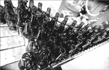  ??  ?? This undated photo supplied by Allagash Brewing Co. shows bottles ready to be filled at the Allagash brewery in Portland, Maine. Tours of Allagash and several other local craft beer companies are among a number of free things for visitors to do in and...