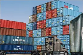  ?? NYT ?? Shipping containers stacked high on docks are sorted and unloaded onto trucks at the Port of Los Angeles. As the network that ferries goods around the world readjusts to pandemic supply chains, products may not be as cheap and easily available as before.