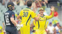  ??  ?? England captain Eoin Morgan looks on in disbelief as Pat Cummins and Steve Smith celebrate another early wicket.