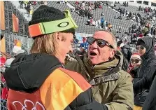  ?? ?? Javi Garcia Perea cooking paella over an open fire, and greeting snowboarde­r son Carlos after his run at the 2018 Winter Olympics in Pyeongchan­g, South Korea.