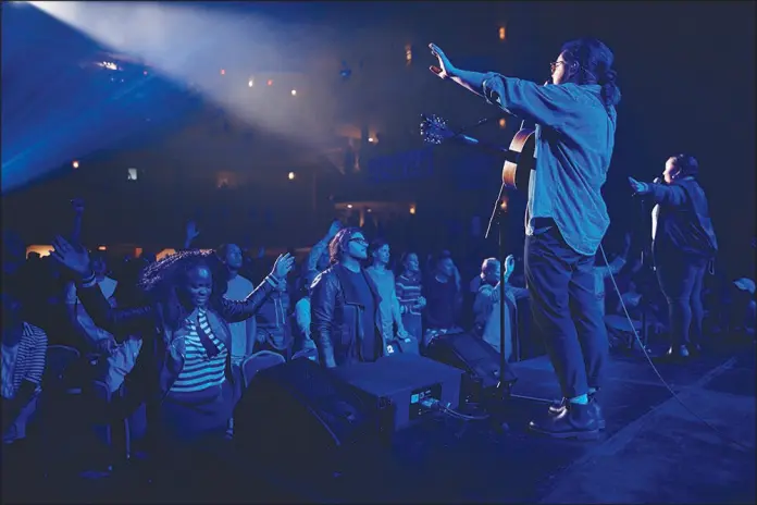  ?? PHOTOS BY ANDRES KUDACKI / ASSOCIATED PRESS FILE (2017) ?? People pray Oct. 22, 2017, during a service at Hillsong Church in New York.