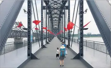  ?? Jonathan Kaiman Los Angeles Times ?? THE BROKEN Bridge in Dandong, China, was bombed by the U.S. during the Korean War to cut off supplies.