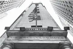  ?? ASSOCIATED PRESS FILE PHOTO ?? The American flag flies above the Wall Street entrance to the New York Stock Exchange.