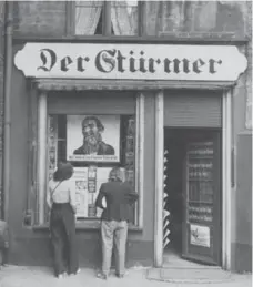  ?? POPPERFOTO/GETTY IMAGES ?? The offices of Nazi newspaper Der Sturmer in Gdansk, circa 1935. A poster in the window reads, “The Jews are our misfortune.”