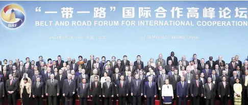  ?? — AP ?? BEIJING: Chinese President Xi Jinping (center) and leaders and delegates attending the Belt and Road Forum pose for a group photo on stage at the China National Convention Center yesterday.