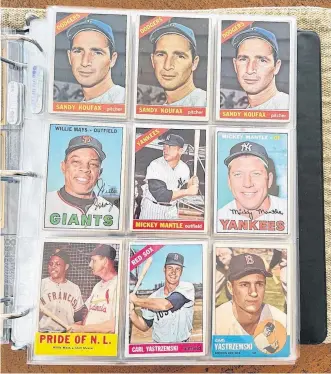  ?? REUTERS ?? An album page shows baseball cards from the 1960s, including Los Angeles Dodgers pitcher Sandy Koufax, New York Yankees outfielder Mickey Mantle and Boston Red Sox outfielder Carl Yastrzemsk­i, in Hoboken, N.J., on Nov. 9, 2021.