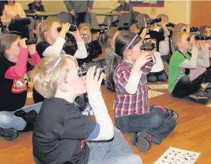  ??  ?? ●● Above: young explorers don their binoculars to identify the different birds; top, the explorers brought the session indoors