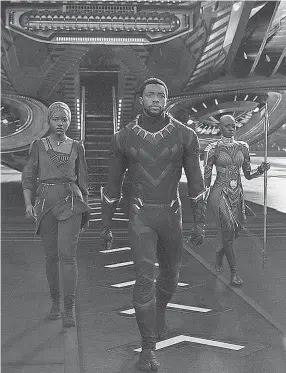  ??  ?? Nakia (Lupita Nyong’o, left) and Okoye (Danai Gurira) stand by their king and his superhero alter ego (Chadwick Boseman) in “Black Panther.” MARVEL STUDIOS