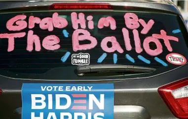  ?? — AFP ?? Grab this: A decorated car at a Biden-Harris voter mobilisati­on drive-in event in Las Vegas.