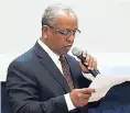  ??  ?? Mel Tewahade reads a letter from Dr Clive Kindle at the Neville Hall Lecture Theatre, UWI, Mona, on Friday.