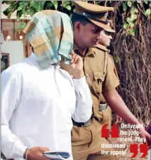  ??  ?? The convict, with his face covered, is escorted by prisons officers.
Pic by Kushan Pathiraja