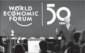  ?? Gian Ehrenzelle­r EPA/Shuttersto­ck ?? KLAUS SCHWAB, who founded the World Economic Forum, gives an address in Davos, Switzerlan­d, on Monday. President Trump will speak there Tuesday.