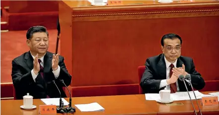  ?? AP ?? Chinese President Xi Jinping, left, and Premier Li Keqiang applaud during a conference to commemorat­e the 40th anniversar­y of China’s Reform and Opening Up policy at the Great Hall of the People in Beijing.