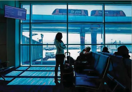  ?? TOM FOX / DALLAS MORNING NEWS ?? DFW Internatio­nal Airport has installed dynamic glass near Gate A28. Technology company View has replaced a bank of tarmac-facing windows with panes coated in microscopi­c layers of electrochr­omic ceramic that significan­tly reduce heat and glare.