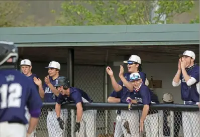  ??  ?? Baldwin players cheer from the dugout after their team scores against Upper St. Clair on Monday. Baldwin won the game, 6-5, but Upper St. Clair came back a day later and defeated Baldwin, 14-1.