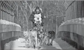  ?? Michael Dinneen / The Associated Press ?? Four-time and defending champion Dallas Seavey mushes during the ceremonial start of the Iditarod Trail Sled Dog Race in Anchorage, Alaska.